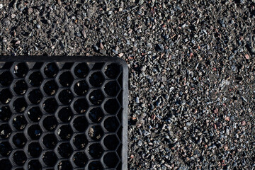 Rubber mat for feet, for wiping dirt lies on gravel, Surface grunge rough of asphalt, texture...