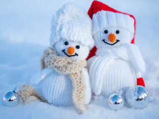 A couple of happy snowmen outside in the snow. Festive Christmas Greeting Card