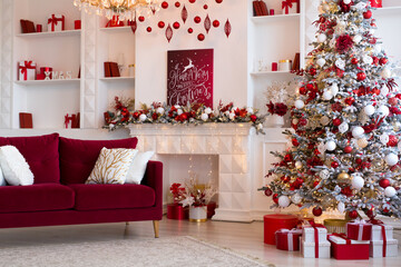 Fototapeta premium Interior of bright modern living room with fireplace, chandelier and comfortable sofa decorated with Christmas tree and red gifts