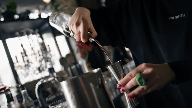 Close-up - the process of preparing a cocktail in a restaurant using a shaker