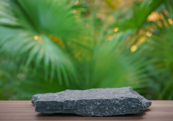 empty rock stone podium texture in tropical outdoor garden green plant gold sunlight blur...
