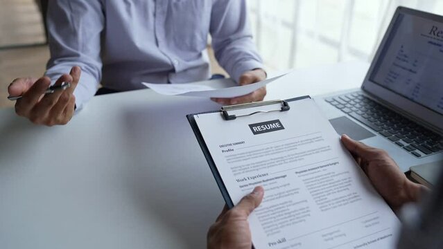 Businessman having an interview for a job, Company hr reading candidate's CV, and interviewing