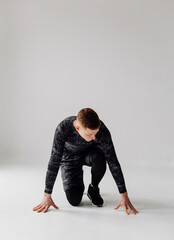 Fototapeta premium Athletic young man doing workouts at home, man doing training, warm up before weight exercise.