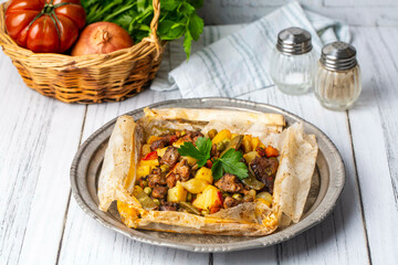 Traditional Turkish food; Meat with vegetables wrapped in greaseproof paper, kebab (Turkish name; Sebzeli kagit kebabi)