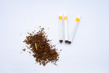 Cigarettes and tobacco powder. Isolated on white background