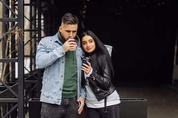 Outdoor happy couple in love posing near cafe