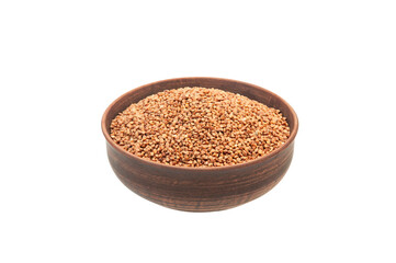 buckwheat in a clay bowl on a white background. the concept of a good harvest of buckwheat