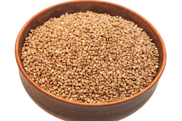 buckwheat in a clay bowl on a white background. the concept of a good harvest of buckwheat