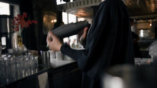 Close-up - the process of preparing a cocktail in a restaurant using a shaker