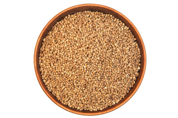 buckwheat in a clay bowl on a white background. the concept of a good harvest of buckwheat