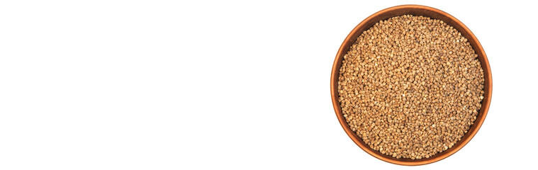buckwheat in a clay bowl on a white background. the concept of a good harvest of buckwheat