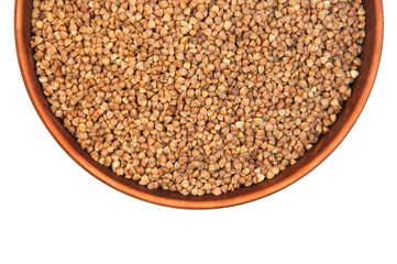 buckwheat in a clay bowl on a white background. the concept of a good harvest of buckwheat