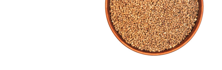 buckwheat in a clay bowl on a white background. the concept of a good harvest of buckwheat