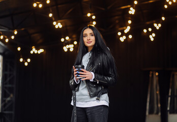 Young caucasian girl with dark long hair in sporty gray hoodie