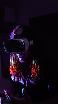 Black man exploring virtual reality under neon light