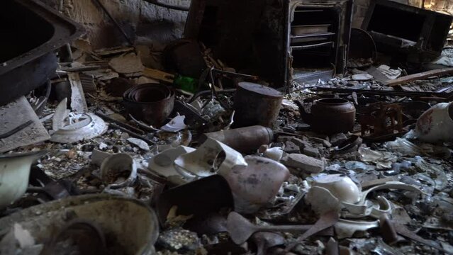 Burned-down apartment building and things close-up. Consequences fire after a shellings. Left belongings of residents. Bombed kitchen. Fire in the house. 