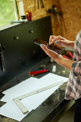 Female business owner using digital tablet in workshop