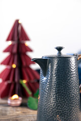 Beautiful textural teapot on a blurred background in a cozy home interior.