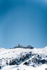 Vertical shot of a beautiful mountain peak covered by snow