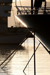 Vertical shot of a yacht tip on a dock at sunset