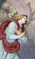 ALAGNA, ITALY - JULY 16, 2022: The fresco of Archangel Gabriel from Annunciation on the facade of church  San Giovanni Battista by Alonzo and Giuseppe Antonio Avondo (1843).