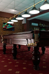 Close-up of billiard table with balls in the billiard club. Side view