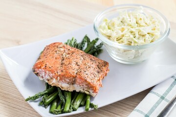 Closeup of a Salmon on Asparagus served on a white plate