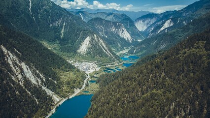 Aerial of the turquoise lake in the scenic Jiuzhaigou valley surrounded by mesmerizing mountains