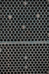 Closeup of a black rusty metal mesh pattern