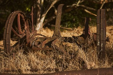 Closeup of old rustic metallic broken wheels on a field