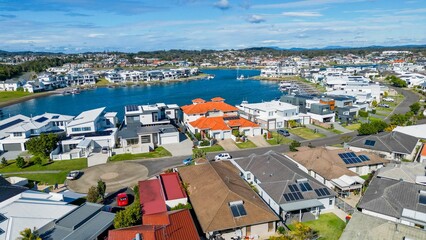 Naklejka premium Aerial view of riverside Port Macquarie town in Australia and Hastings River under blue cloudy sky