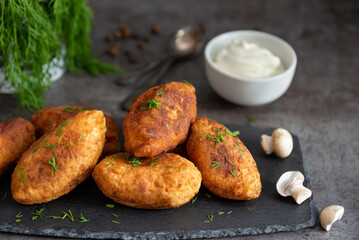 Fried patties with potatoes, mushrooms and green onions, homemade food