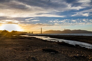 Golden gate bridge of San Francisco with river and cloudy sky at sunset