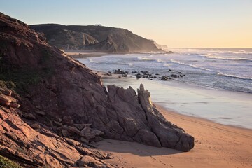 Beautiful sunset over the rocky beach in Algarve, Portugal.
