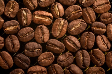 Coffee beans close up. Texture with roasted coffee beans.