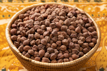 Basket with brown indian Kala Chana chickpeas close up 
