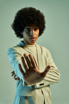Stylish Hispanic man with stop gesturing