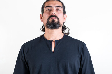 Latin handsome serious man looking at camera over white background.