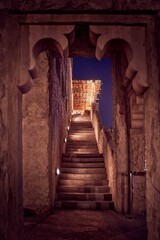 Vertical shot of stunning old Arabic market in the Middle East with lighted staircase at night
