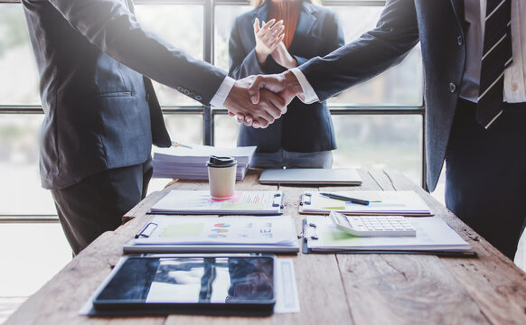 Business handshake for teamwork of business merger and acquisition,successful negotiate,hand shake,Asian businessman shake hand with partner to celebration partnership and business deal concept