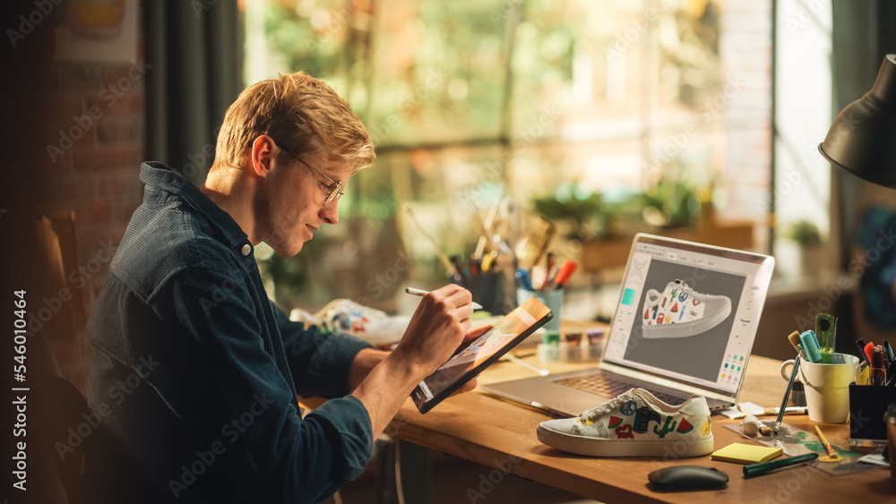 Poster experienced male teen designer works with digital graphics tablet touchscreen, drawing sketch of a n