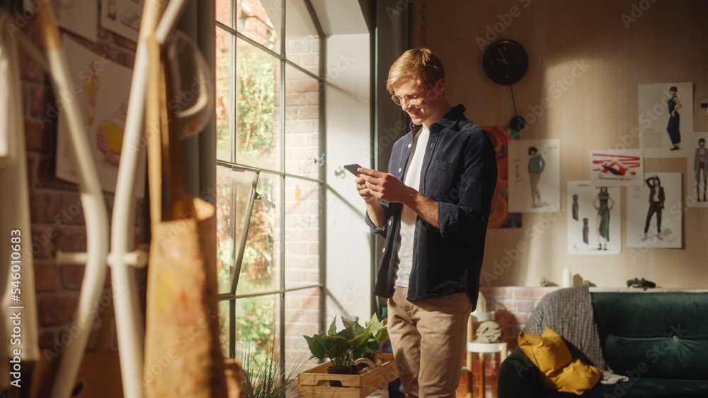 Poster caucasian man using smartphone while resting at home. happy male blogger creating funny content and 