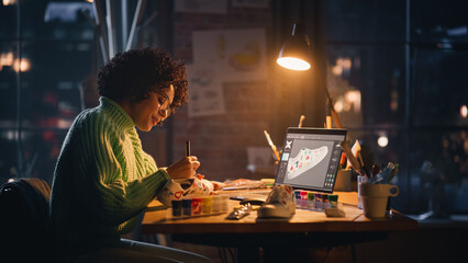 Creating Trendy Design. Black Woman Feels Inspired While Drawing in the Evening. Female Designer Puts Patterns on Shoe Comparing with 3D Model on the Laptop Computer Screen.