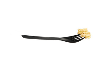 a slice of dry instant noodles strung on a disposable plastic fork in black on a white background