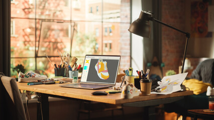 Stylish Empty Workspace of Footwear Designer. Laptop Computer On The Desk with CAD 3D Editing Software on Display. Home Office In Stylish Loft Apartment Living Room Concept.