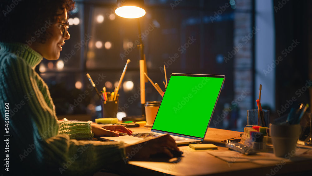 Poster positive female designer working from home on laptop computer with green screen chromakey on display
