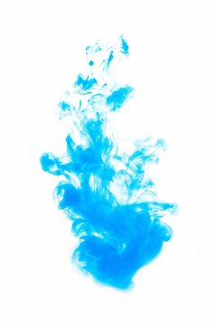 Vertical shot of of a blue ink drop into the water isolated on an empty white background