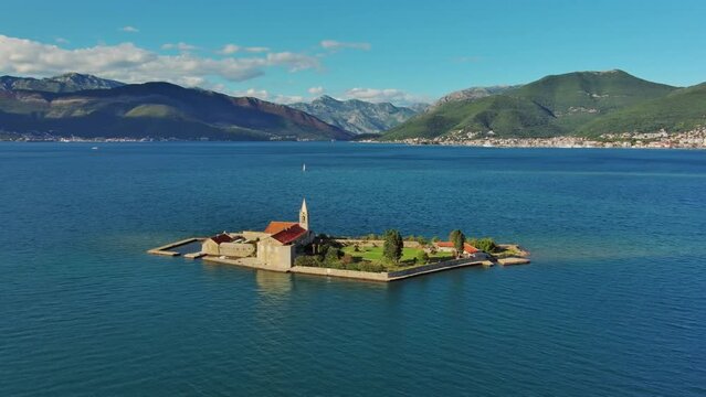 Aerial around view of the island of Notre Dame de la Misericorde, monastery in the Bay of Kotor, Montenegro. Ostrvo Gospa od Milosrda, 4k