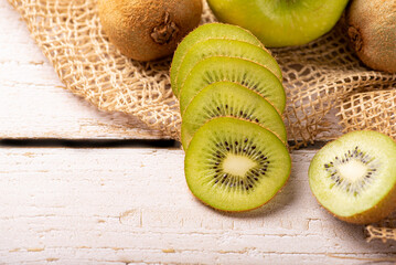 Green apple and kiwi, green apples and kiwi fruit laid on rustic wood with rustic fabric, selective...
