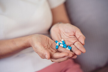 The picture of the drug in the hand of an elderly woman is a patient who has to take regular medication every day.